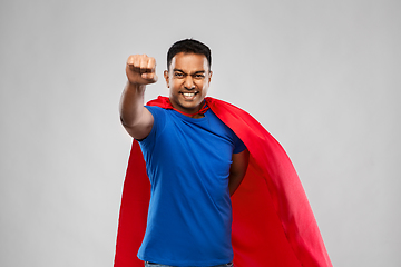 Image showing indian man in superhero cape flying over grey