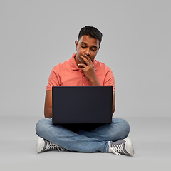 Image showing thinking indian man with laptop computer