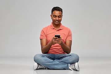Image showing happy indian man using smartphone
