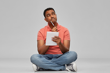 Image showing indian man in polo shirt with notebook and pen