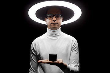 Image showing man in glasses with smart speaker under lamp