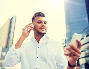 Image showing man with headphones and smartphone listening music