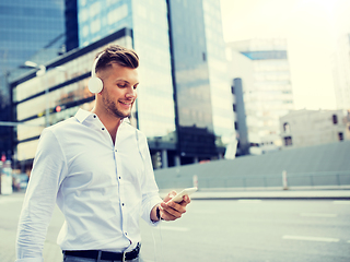 Image showing man with headphones and smartphone listening music