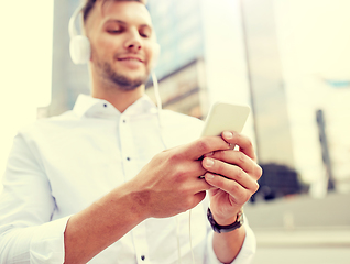 Image showing man with smartphone and headphones listening music