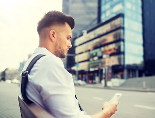 Image showing man with smartphone and bicycle in city