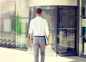 Image showing young man with folder on city street