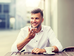 Image showing man with coffee and smartphone at city cafe