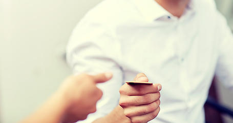 Image showing close up of man giving credit card to waiter