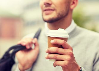 Image showing close up of man with coffee cup on street