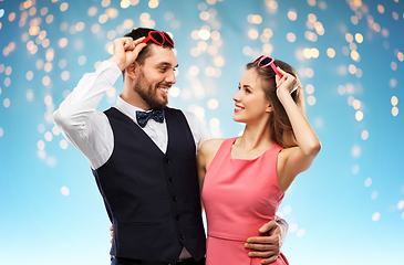 Image showing happy couple in heart-shaped sunglasses