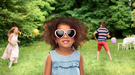 Image showing little african girl in sunglasses at summer party