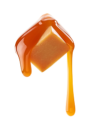 Image showing caramel sauce flowing on flying caramel candy