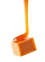 Image showing caramel sauce flowing on flying caramel candy