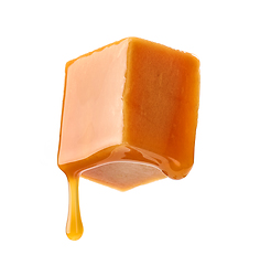 Image showing caramel sauce flowing on flying caramel candy