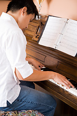 Image showing Asian playing piano