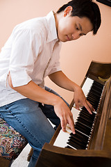 Image showing Asian playing piano