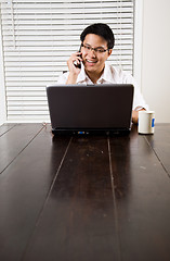 Image showing Asian entrepreneur on the phone