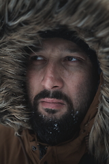 Image showing man at winter in stormy weather wearing warm fur jacket