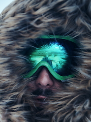 Image showing man at winter in stormy weather wearing warm fur jacket