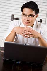 Image showing Working asian entrepreneur