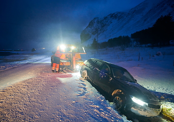 Image showing Car being towed after accident in snow storm