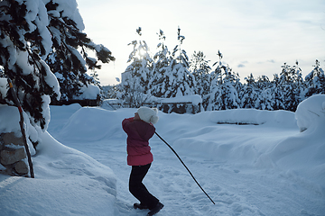 Image showing girl throwing fresh snow at beautiful sunny winter day