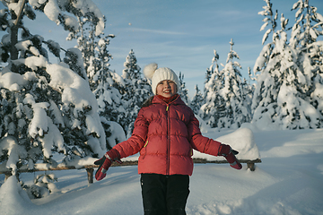 Image showing girl throwing fresh snow at beautiful sunny winter day