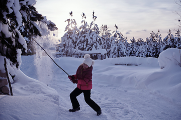 Image showing girl throwing fresh snow at beautiful sunny winter day