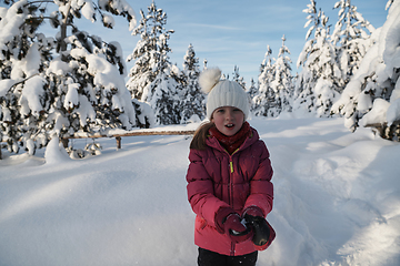 Image showing girl throwing fresh snow at beautiful sunny winter day