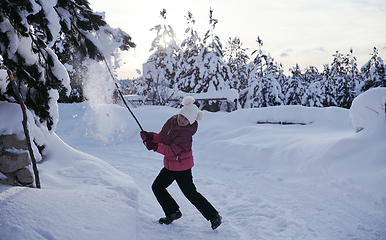 Image showing girl throwing fresh snow at beautiful sunny winter day