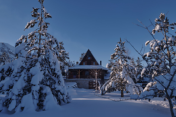 Image showing wooden cabin with fresh snow on cold winter morning