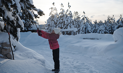 Image showing girl throwing fresh snow at beautiful sunny winter day