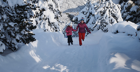 Image showing mother and daughter walking at beautiful sunny winter day