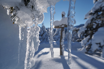 Image showing wooden cross covered with fresh snow at beautiful fresh winter morning