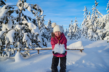 Image showing girl throwing fresh snow at beautiful sunny winter day