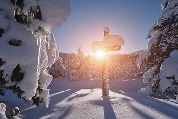 Image showing wooden cross covered with fresh snow at beautiful fresh winter morning