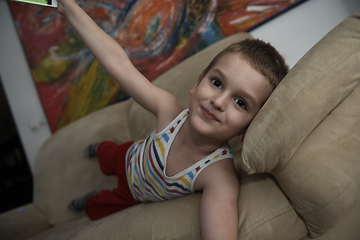 Image showing Little boy child playing with creative toys