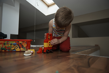 Image showing Little boy child playing with creative toys