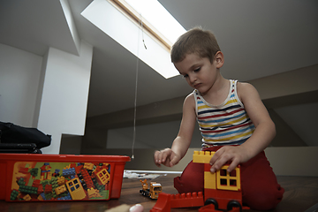 Image showing Little boy child playing with creative toys