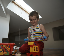 Image showing Little boy child playing with creative toys