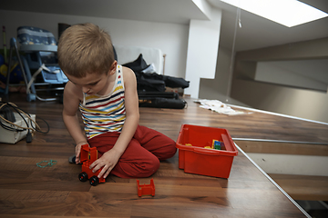 Image showing Little boy child playing with creative toys