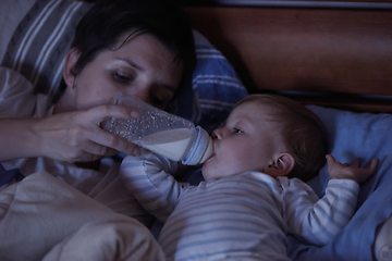 Image showing baby eating milk from bottle