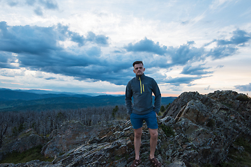 Image showing Man standing on top of cliff