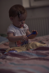 Image showing cute little one year old baby and making first steps in bed