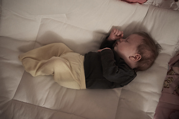 Image showing One month newborn baby sleeping in bed