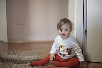 Image showing cute little one year old baby and making first steps