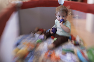 Image showing cute little baby playing in mobile bed