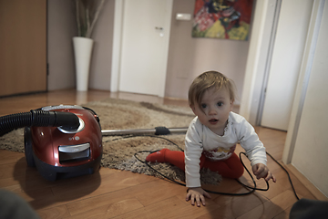 Image showing cute little one year old baby and making first steps