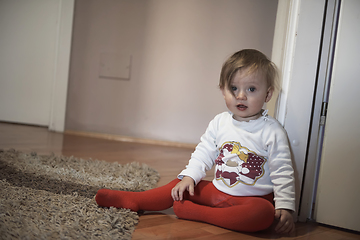 Image showing cute little one year old baby and making first steps