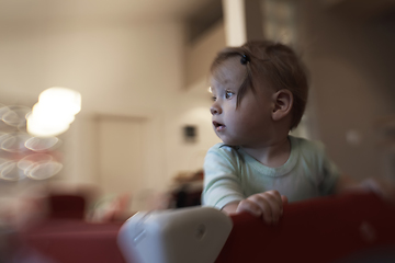 Image showing cute little baby playing in mobile bed